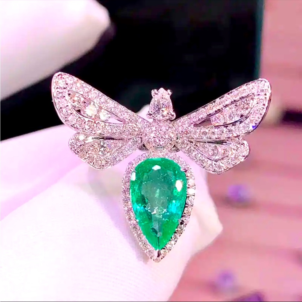 Crystal butterfly ring with pear shaped green stone set in silver-tone ring